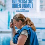 Eine Reinigungskraft mit einem Wischmob-Stiel in der Hand und einem Overall - Ich verstehe ihren Unmut